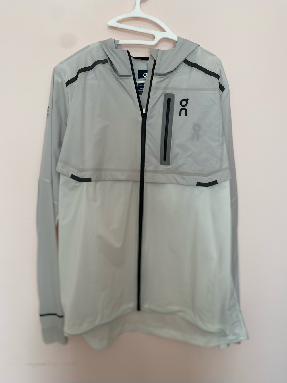 On Running All Weather women’s white and light gray hooded lightweight jacket